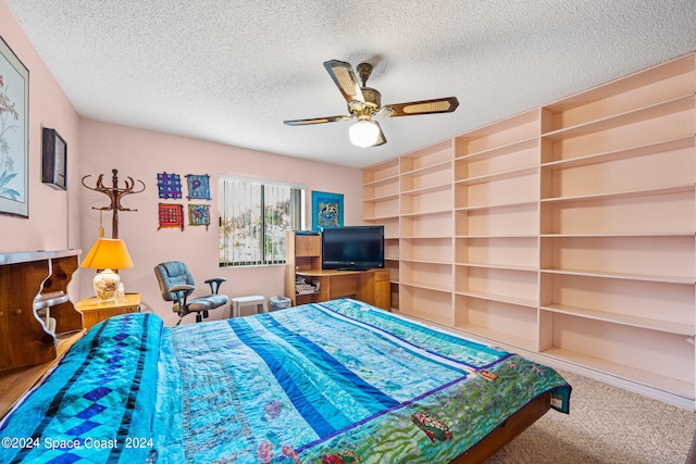 bedroom featuring ceiling fan, carpet flooring, and a textured ceiling