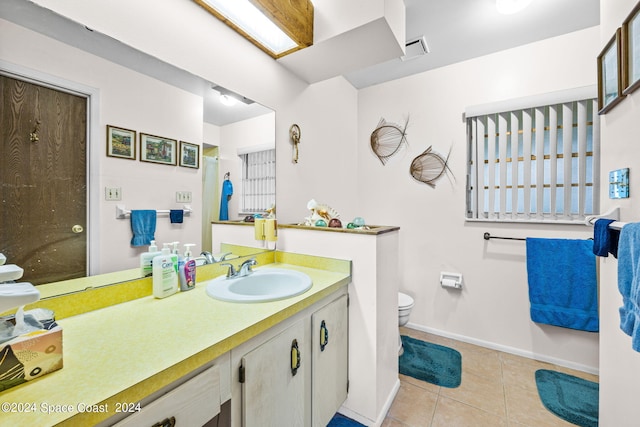 bathroom with tile patterned floors, vanity, and toilet