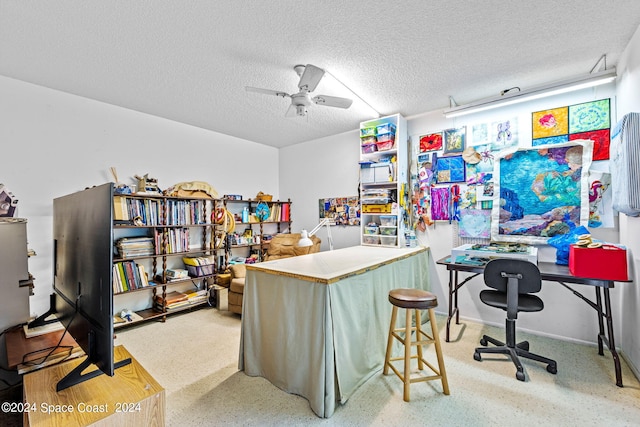 home office featuring ceiling fan and a textured ceiling