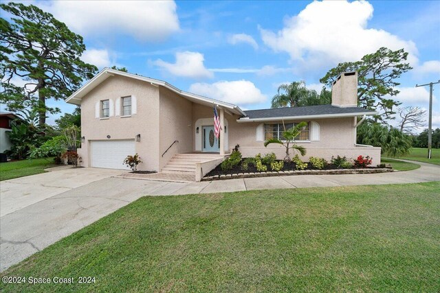 view of front of home featuring a garage and a front lawn