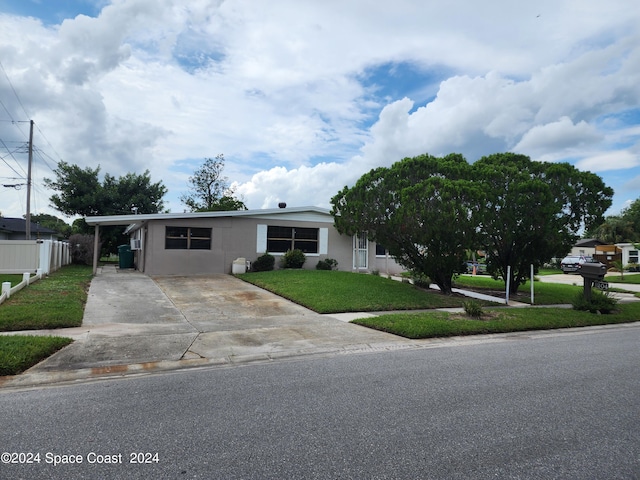 view of front of home with a front lawn and a carport