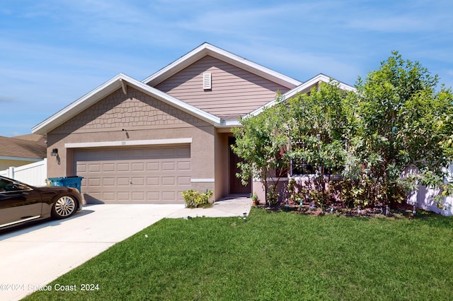 view of front of house featuring a garage and a front yard