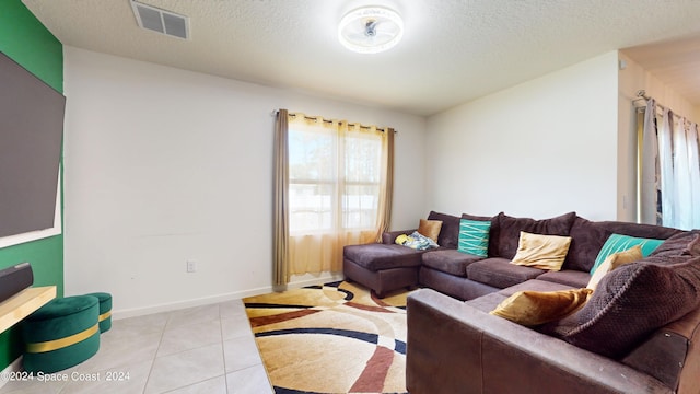 living room featuring a textured ceiling and light tile patterned flooring