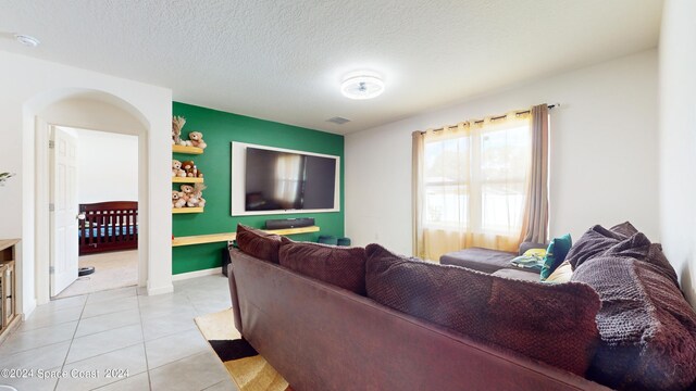 tiled living room with a textured ceiling