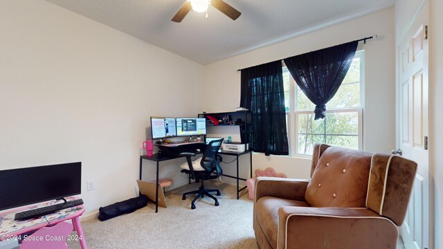 carpeted home office featuring ceiling fan