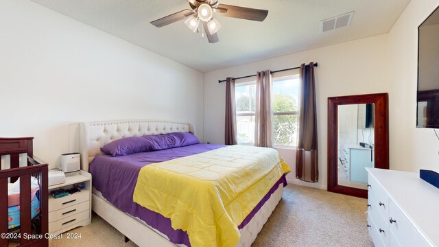 bedroom with light carpet and ceiling fan