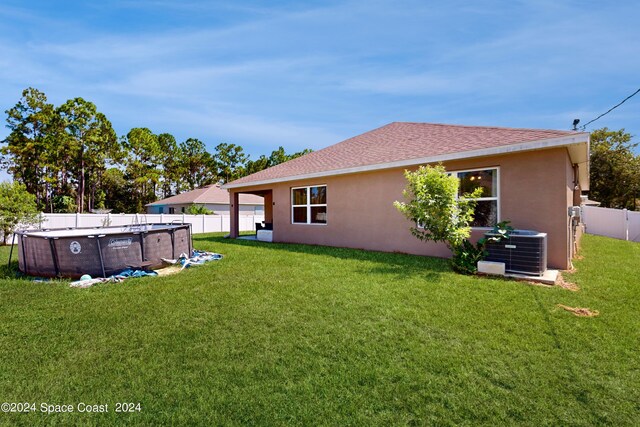 exterior space with cooling unit and a fenced in pool