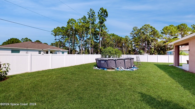 view of yard with a fenced in pool