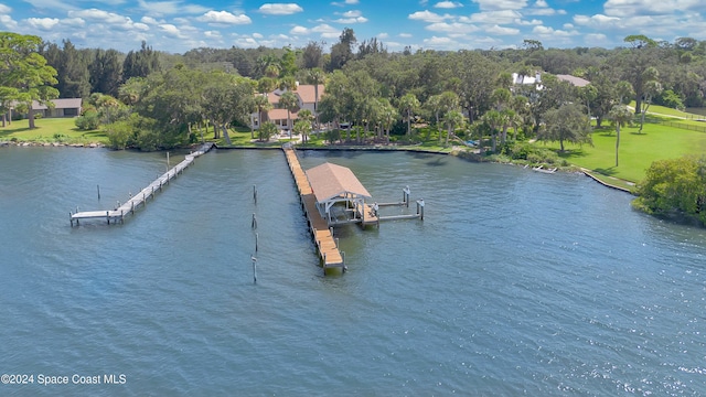 dock area with a lawn and a water view