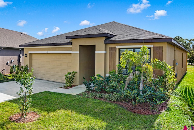 view of front of house featuring a garage and a front lawn