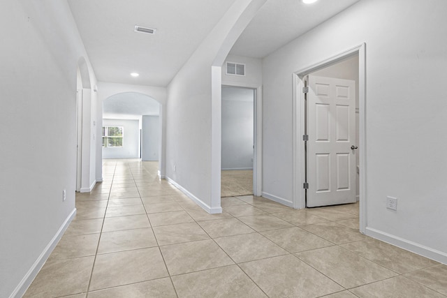 hall featuring light tile patterned floors