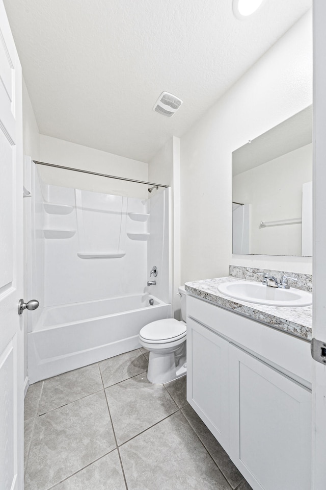 full bathroom with tile patterned floors, toilet, vanity, shower / bathing tub combination, and a textured ceiling