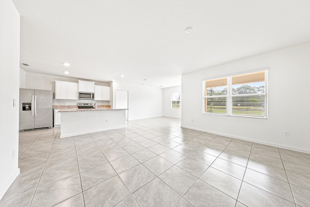 unfurnished living room with light tile patterned floors