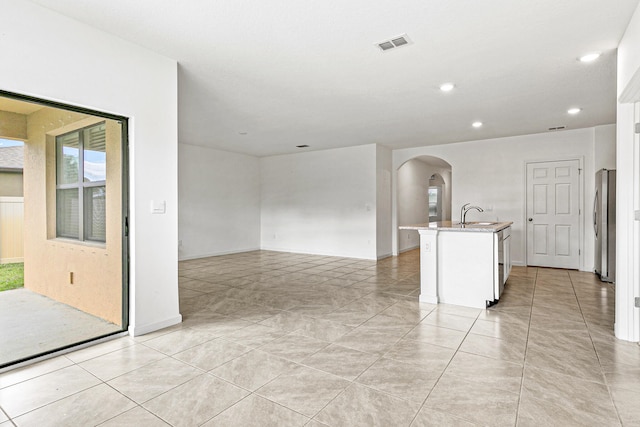 unfurnished room featuring light tile patterned floors and sink