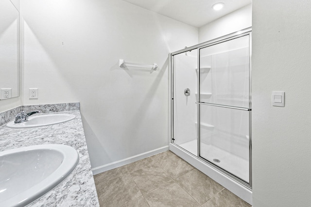 bathroom featuring vanity, tile patterned flooring, and a shower with door