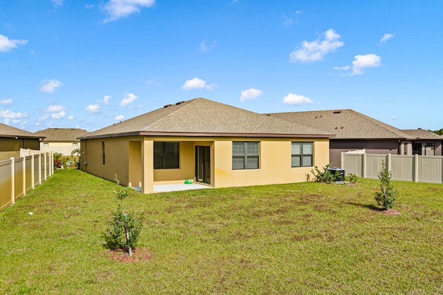 back of house featuring a yard and a patio area