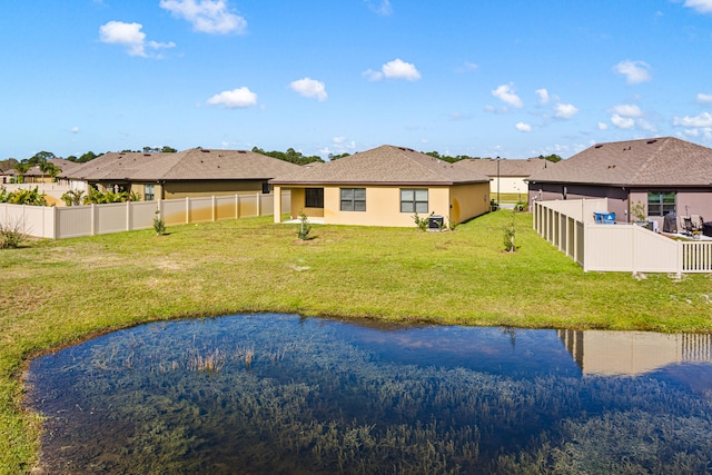 rear view of property featuring a yard