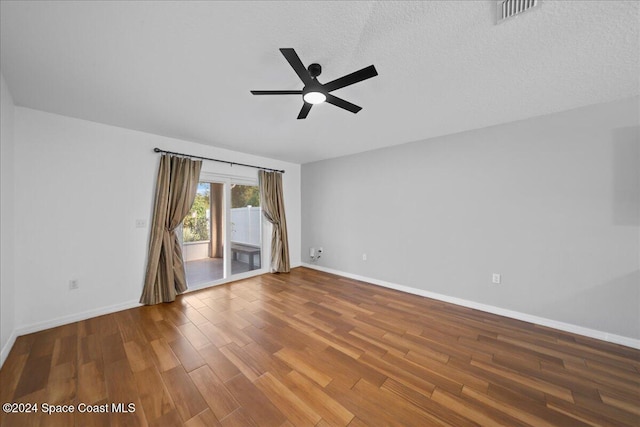 spare room featuring ceiling fan, hardwood / wood-style floors, and a textured ceiling