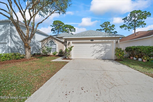 view of front of house with a garage and a front yard