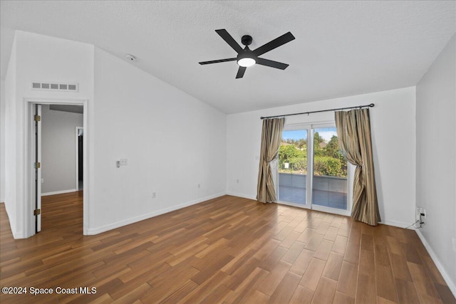 spare room with vaulted ceiling, ceiling fan, dark hardwood / wood-style flooring, and a textured ceiling