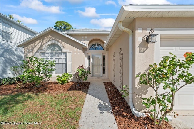 doorway to property featuring a garage