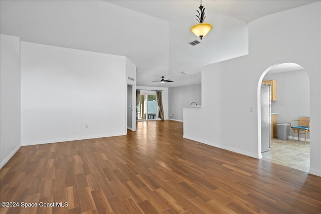 unfurnished living room with ceiling fan and hardwood / wood-style floors