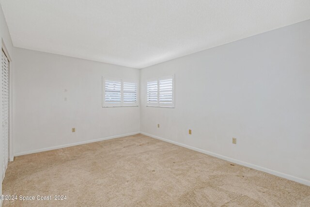 unfurnished bedroom with light colored carpet