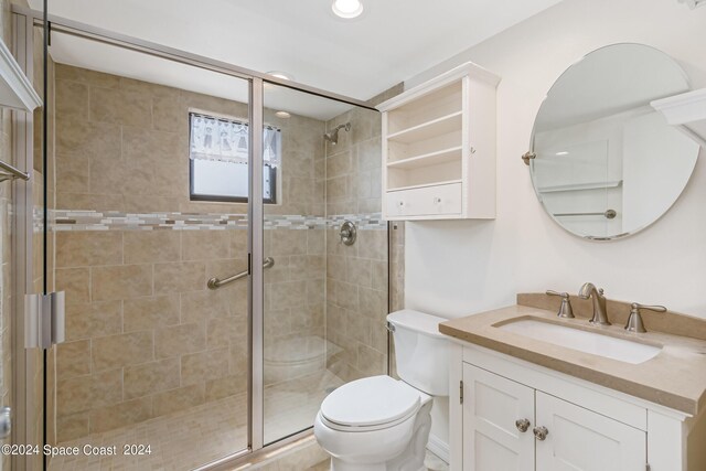 bathroom featuring walk in shower, vanity, and toilet