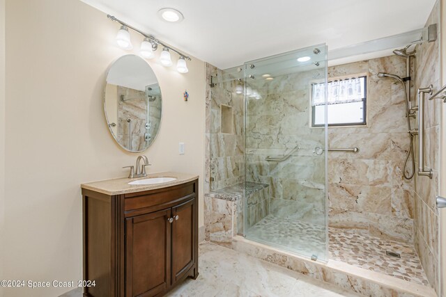 bathroom featuring vanity and an enclosed shower