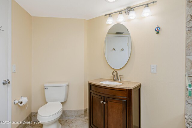 bathroom featuring tile patterned floors, vanity, and toilet