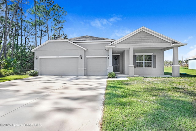 view of front of property featuring a garage and a front lawn