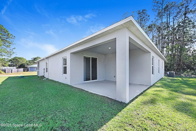 back of property featuring central AC, a patio area, and a lawn