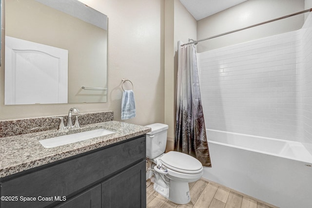 full bathroom featuring vanity, shower / tub combo, and toilet