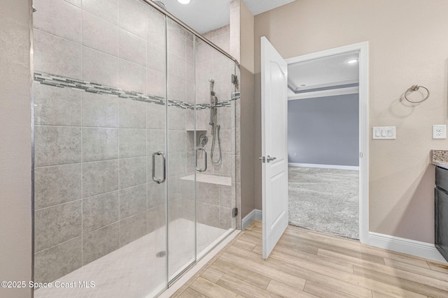 bathroom featuring vanity and an enclosed shower