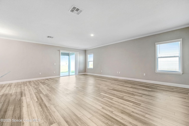 unfurnished room featuring light hardwood / wood-style floors and ornamental molding