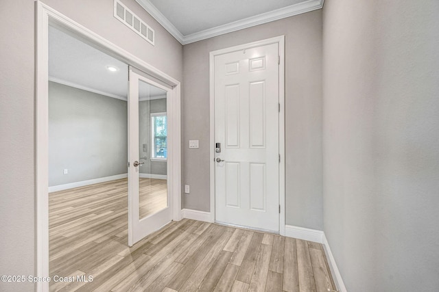 foyer entrance featuring light wood-type flooring and crown molding