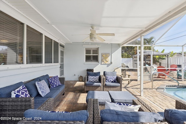 deck with a patio, a fenced in pool, a lanai, an outdoor hangout area, and ceiling fan