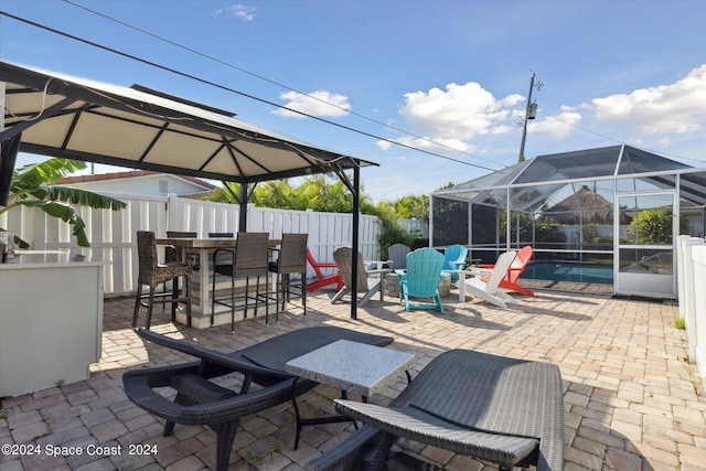 view of patio / terrace with glass enclosure and a fenced in pool