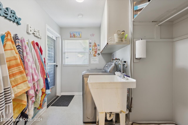 washroom featuring washing machine and clothes dryer, carpet, cabinets, and sink