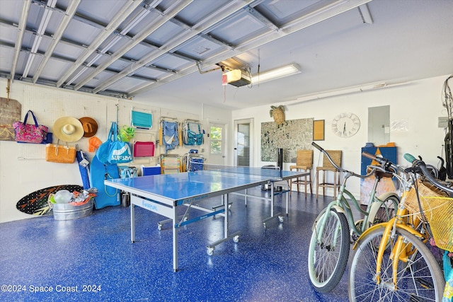 garage with a garage door opener and electric panel