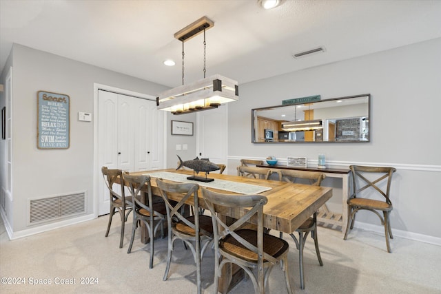 dining area with light colored carpet