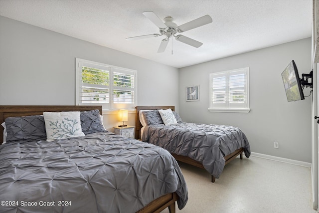 bedroom with a textured ceiling and ceiling fan