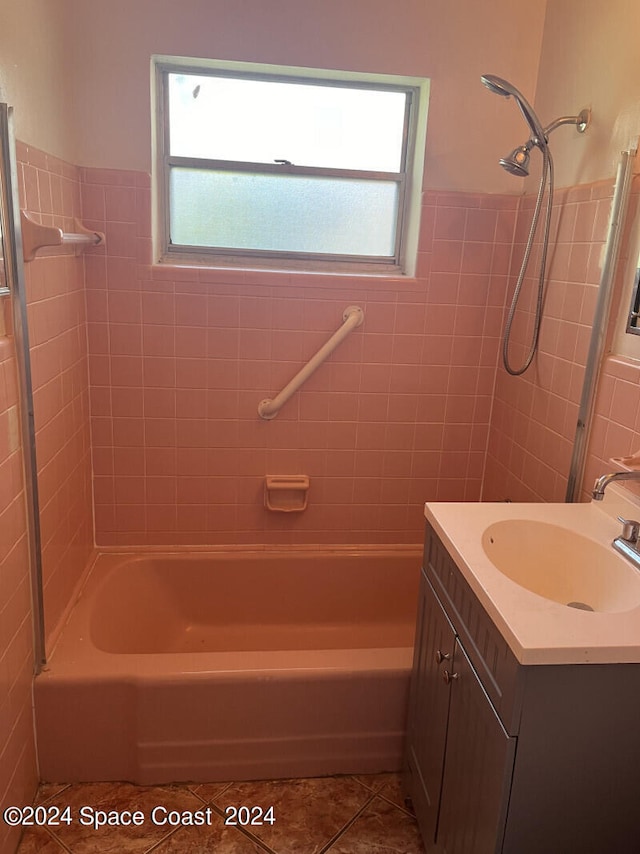 bathroom featuring tiled shower / bath combo, vanity, and tile patterned floors