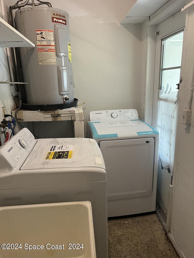 laundry area with water heater and separate washer and dryer