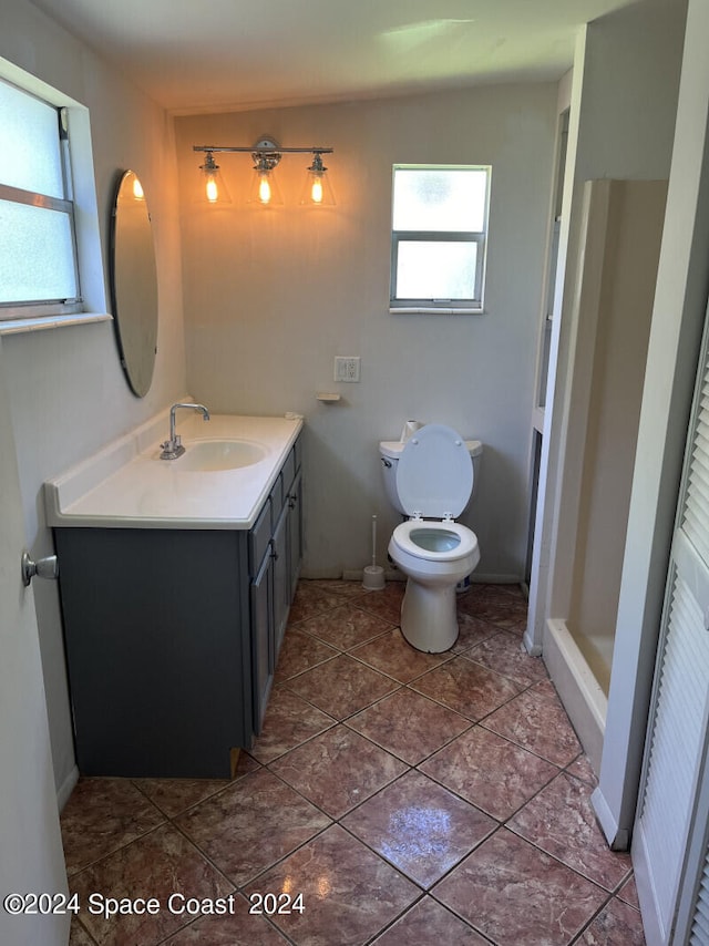 bathroom with tile patterned floors, vanity, and toilet