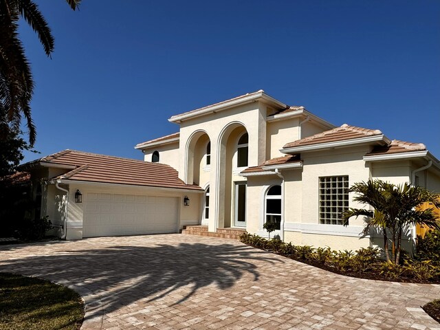 mediterranean / spanish house featuring a garage