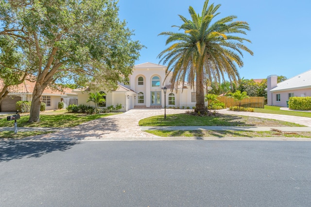 mediterranean / spanish house with a front lawn