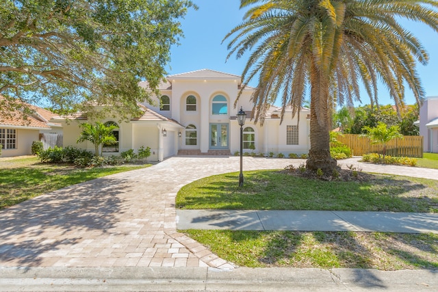 mediterranean / spanish-style home featuring a front yard