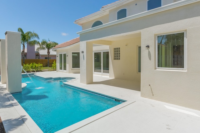 exterior space featuring pool water feature and a patio