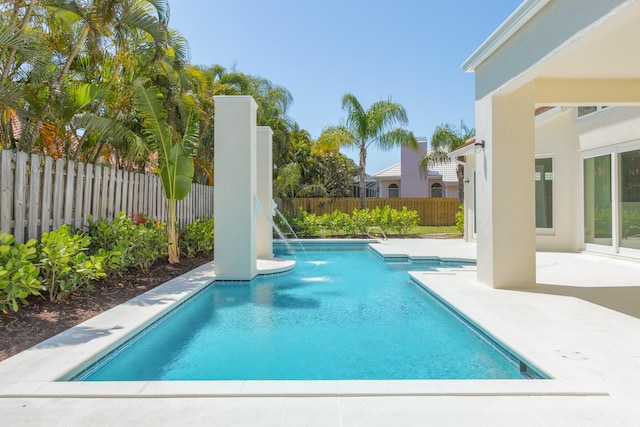 view of swimming pool with a patio and pool water feature